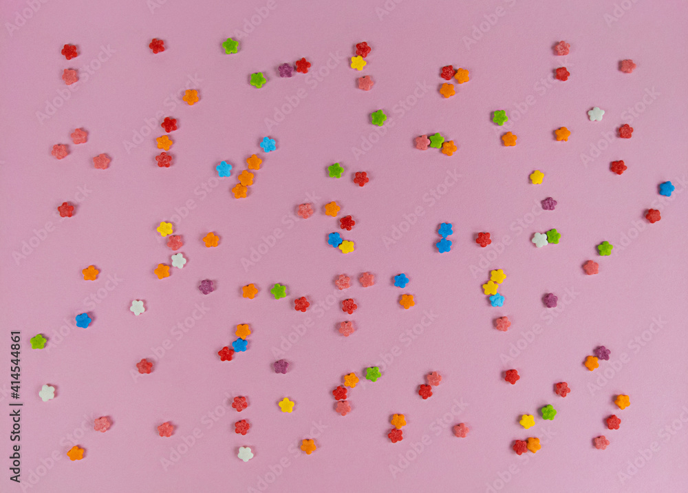 Colorful sweet confetti flowers on pink backgroud. Colorful sweet confetti flowers on pink backgroud.