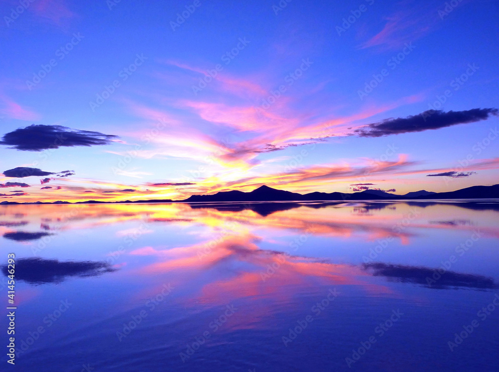 Magical pink sunset over ocean, surreal fantasy landscape, incredible sky clouds reflection in water, romantic evening.