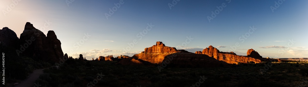 Panorama shot of red sandstones hills at golden hour in Arches national park in Utah, america