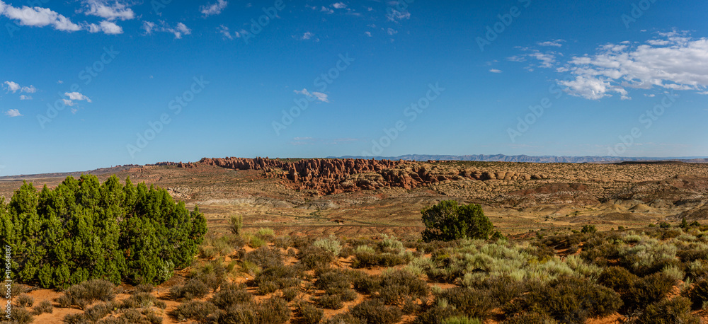 Naklejka premium Panorama shot of red sandstones monoliths in desert of Arches national park in Utah, america