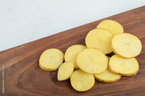 Pile of sliced potato on wooden board