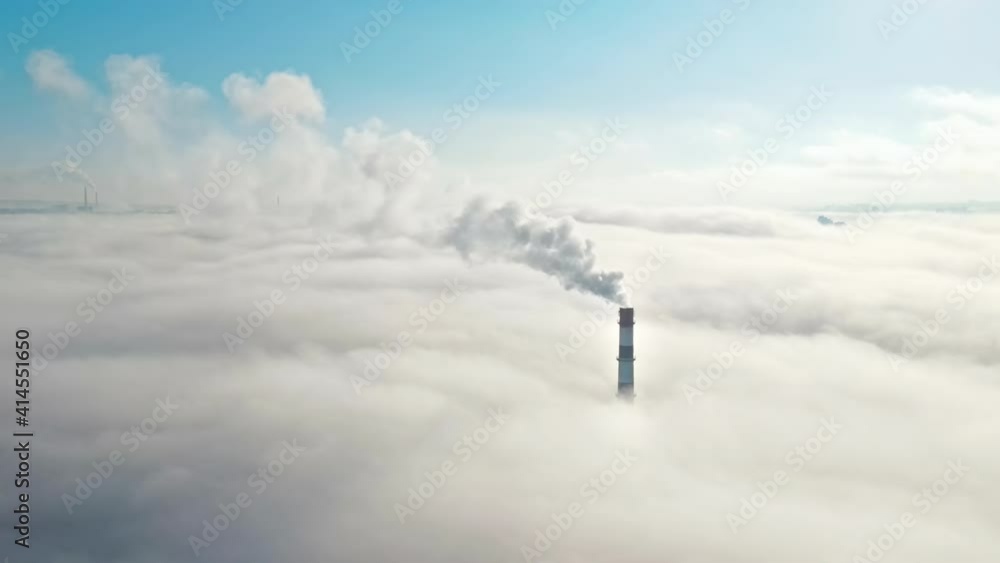 Aerial drone view of Chisinau. Tube of the thermal station with smoke coming out above the low clouds. Visible buildings. Moldova Aerial drone view of Chisinau. Tube of the thermal station with smoke coming out above the low clouds. Visible buildings. Moldova