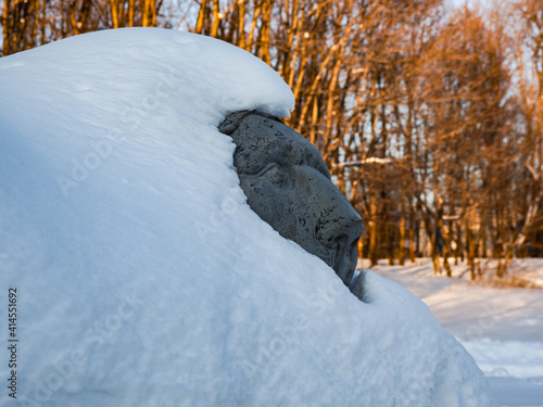 sculpture of a lion under snow