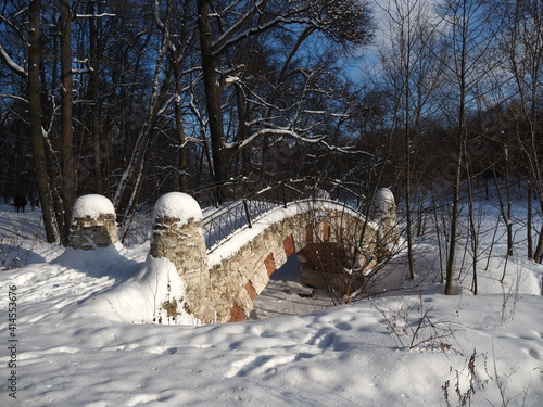 stone humpback bridge under snow