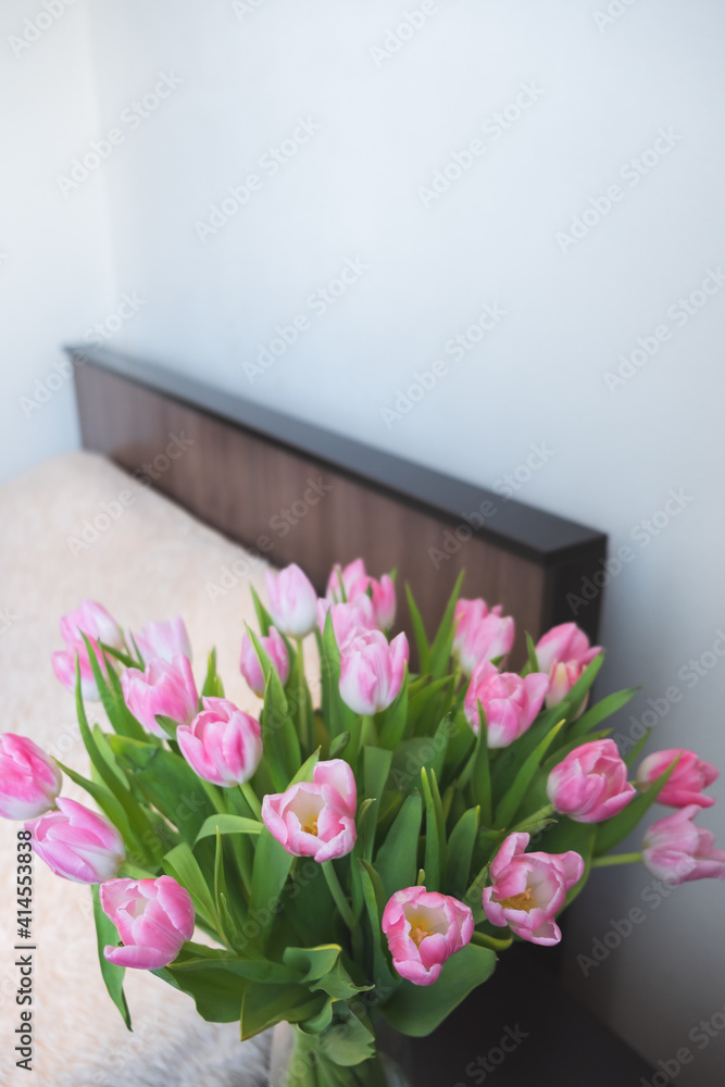 pink tulips on the background of the room pink tulips on the background of the room