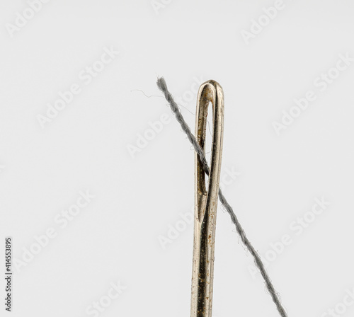 sewing needle eye and thread © russell102