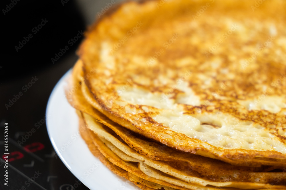 a stack of pancakes on a white plate a stack of pancakes on a white plate