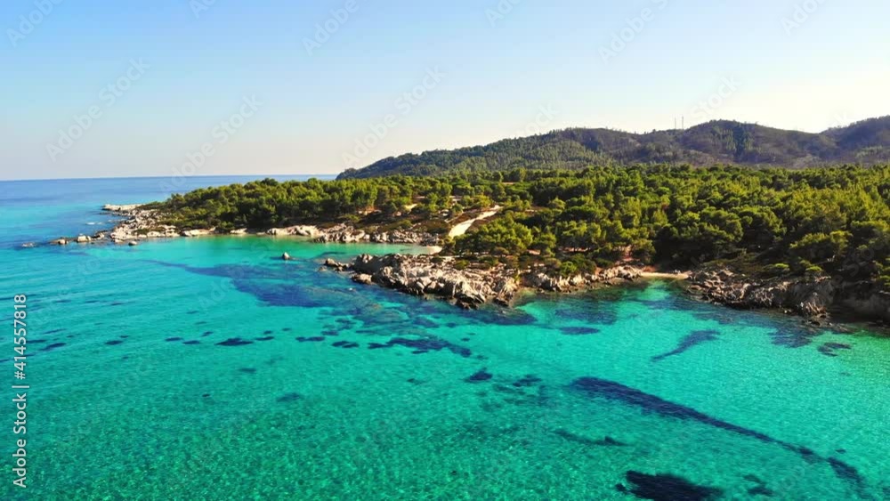 Aerial drone view of the Aegean sea rocky coast with blue transparent water, multiple greenery, hills. Greece Aerial drone view of the Aegean sea rocky coast with blue transparent water, multiple greenery, hills. Greece