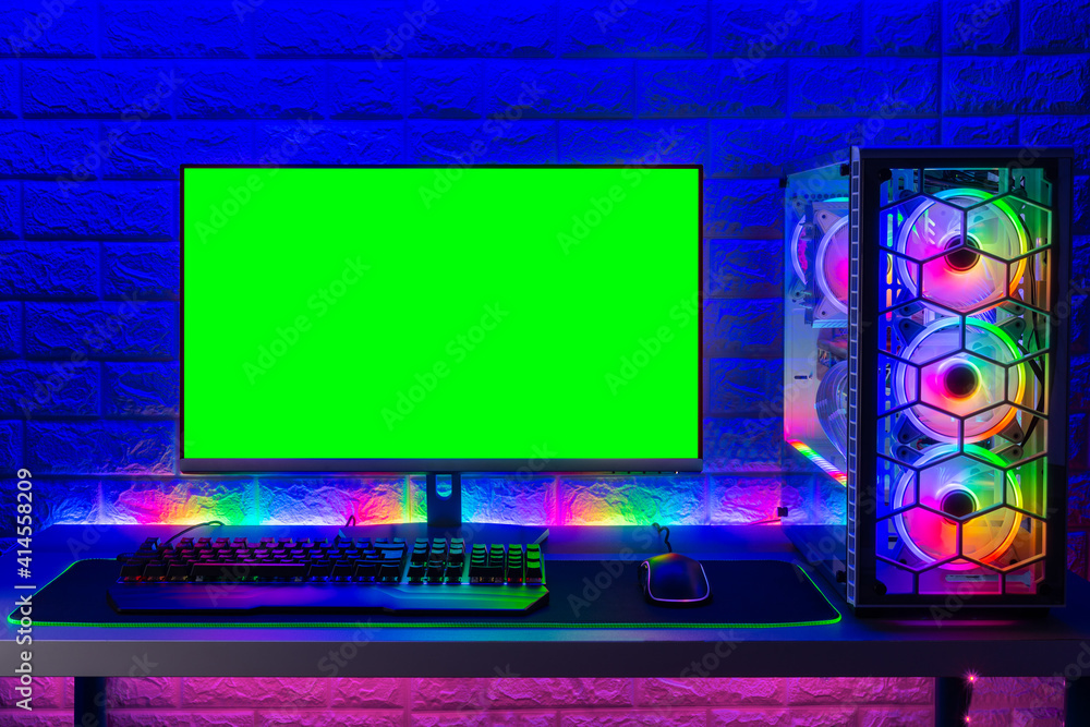 colorful bright illuminated rgb gaming pc with keyboard mouse monitor with  green screen copy space front of LED light brick stone wall. Computer  playing hardware games background Stock Photo | Adobe Stock