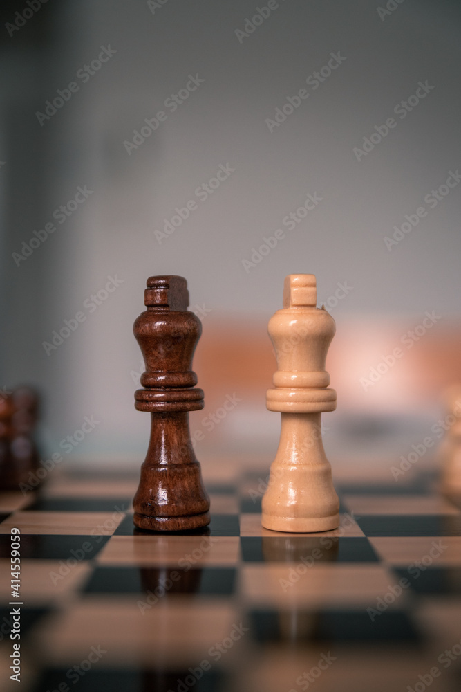 Chess pieces set up ready to play chess game on a wooden board strategy game kings head to head deadlocked Chess pieces set up ready to play chess game on a wooden board strategy game kings head to head deadlocked