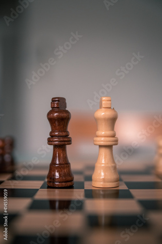 Chess pieces set up ready to play chess game on a wooden board strategy game kings head to head deadlocked