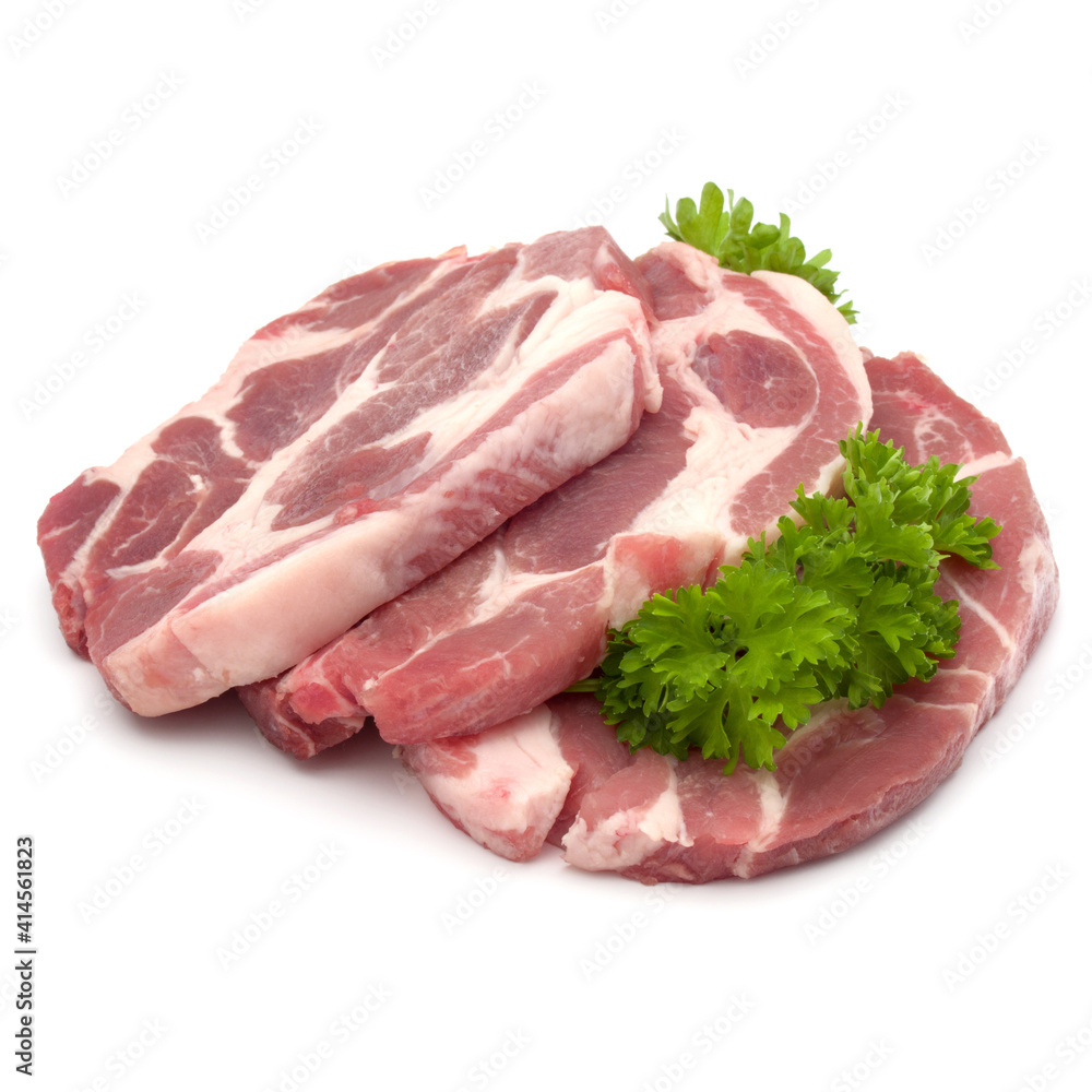 Raw pork neck chop meat with parsley herb leaves garnish isolated on white background cutout Raw pork neck chop meat with parsley herb leaves garnish isolated on white background cutout