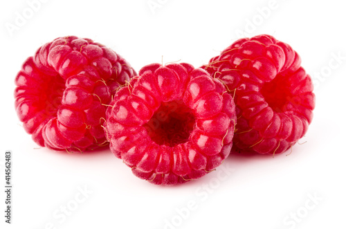 three ripe raspberries isolated on white background close up