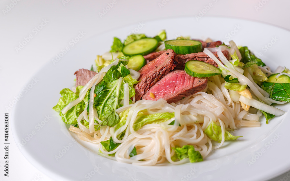 Roasted stake with rice noodle and fresh Napa salad. Homemade summer healthy eating food. Roasted stake with rice noodle and fresh Napa salad. Homemade summer healthy eating food.