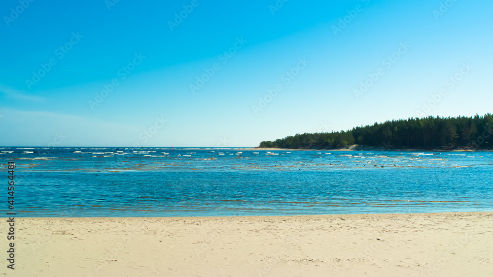beach.in the photo, the sea shore against the blue sky