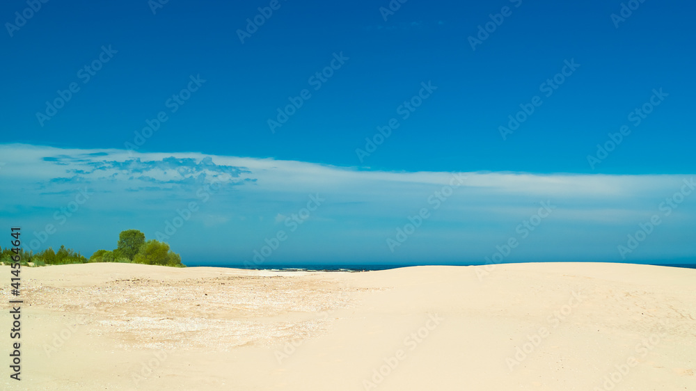 beach.in the photo, the sea shore against the blue sky beach.in the photo, the sea shore against the blue sky