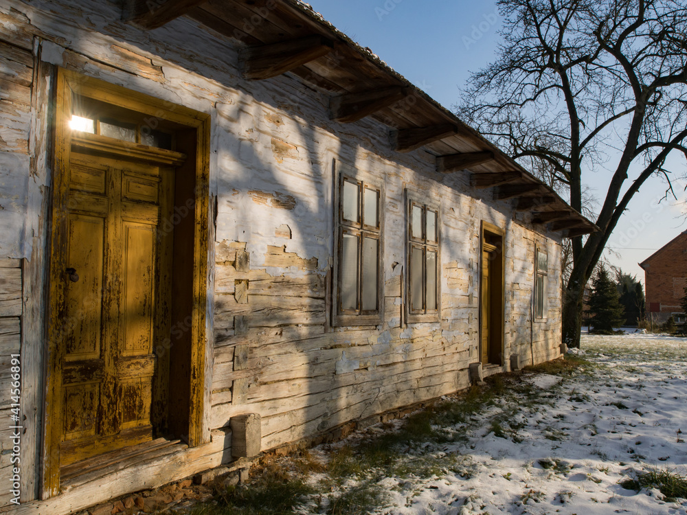 Fototapeta premium White wooden log house with yellow door