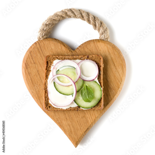 Open faced vegetable sandwich canape or crostini on a wooden serving board isolated on white background closeup. Top view. Vegetarian tartarine.