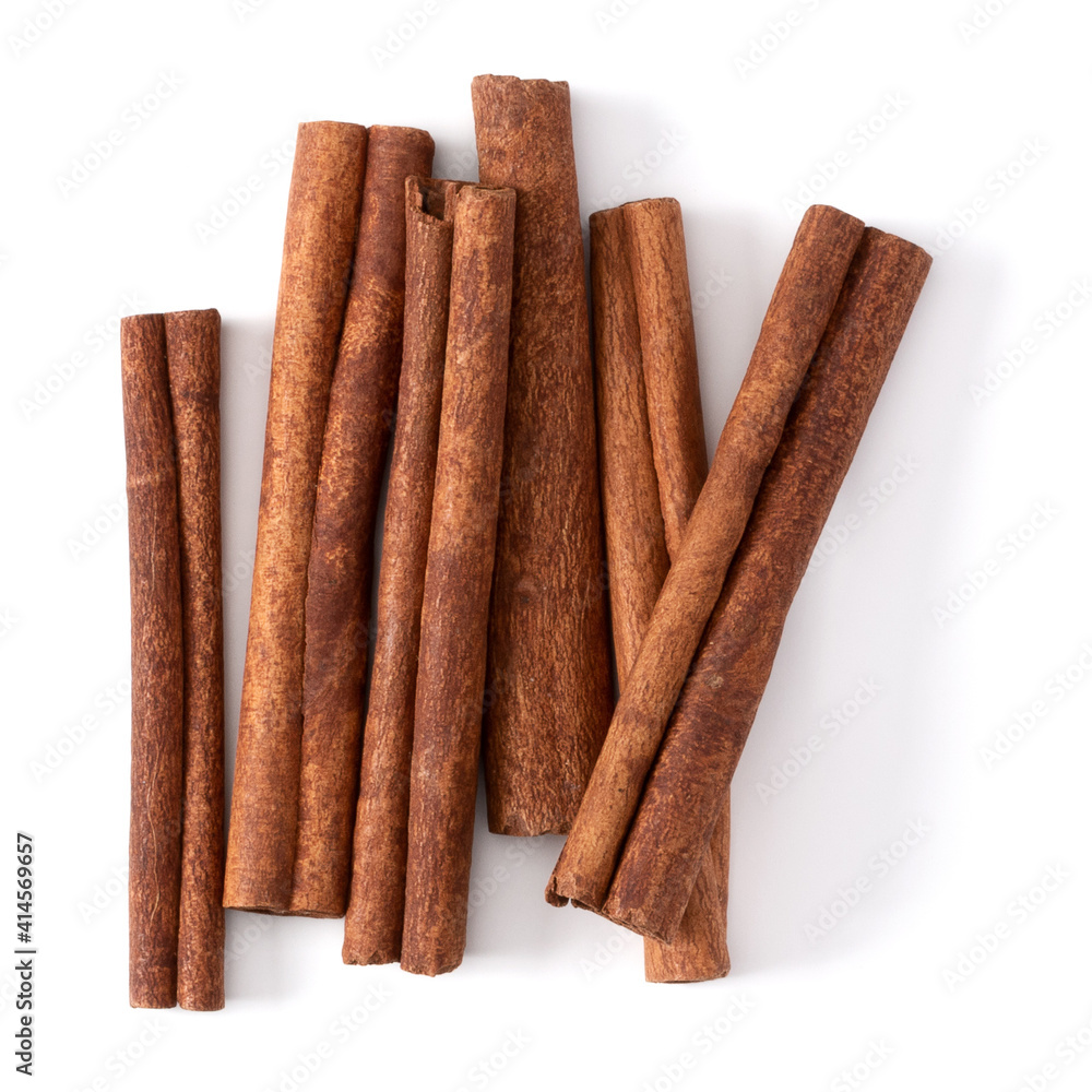 Cinnamon sticks isolated on white background closeup. Canella spice. Aromatic condiment background. Flat lay, top view.