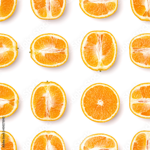 Seamless pattern of orange fruit halves. Orange fruit isolated on white background. Food background. Flat lay, top view.