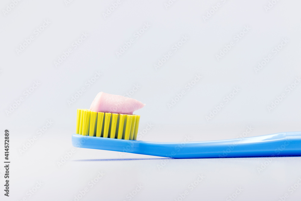 Toothbrush with toothpaste on gray background with copy space. Dental concept. Toothbrush with toothpaste on gray background with copy space. Dental concept.