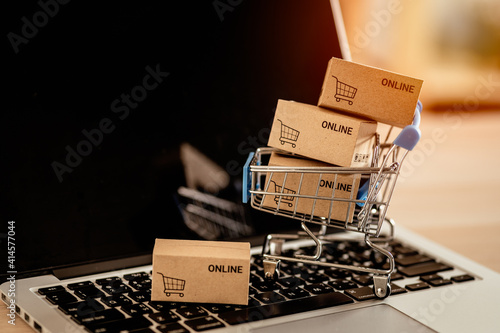 small carton box with cart shopping on laptop keyboard ,online shopping and e-commerce concept.