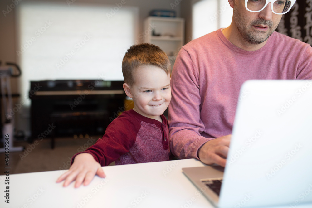 dad and son on a computer dad and son on a computer