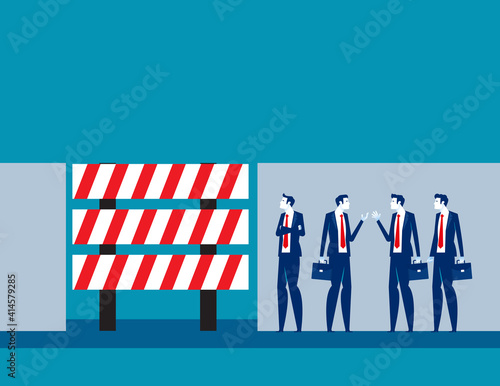 Business people discuss in front of dead end sign board