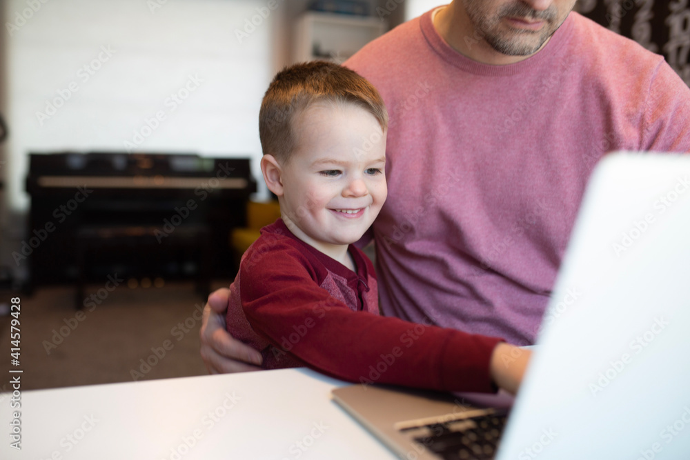dad and son on a computer dad and son on a computer