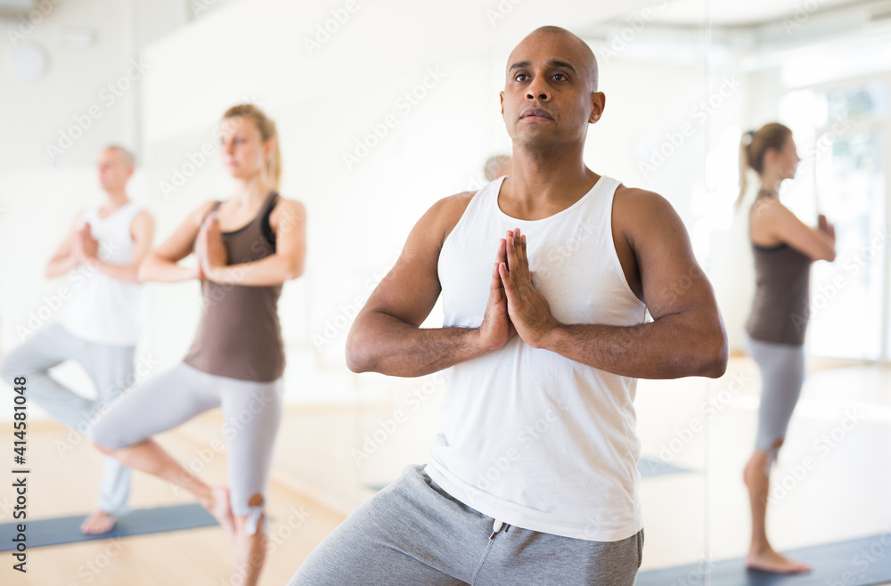 People studying new position at yoga modern school
