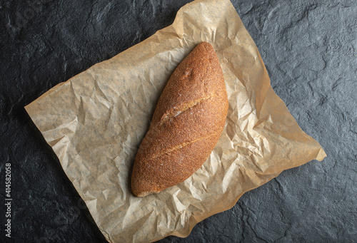 Freshly baked British baton loaf bread on board photo