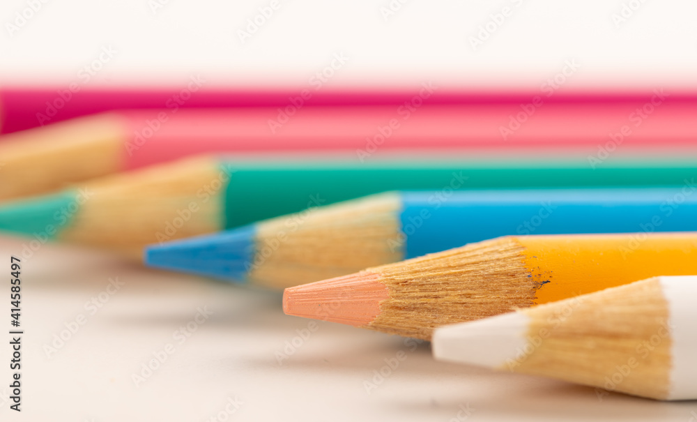 Colored pencils row on white background Colored pencils row on white background