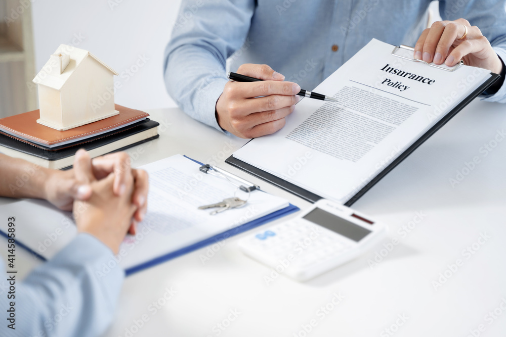 home loan insurance. .Real estate broker and client sign contract insurance agreement document. Business meeting concept home loan insurance. .Real estate broker and client sign contract insurance agreement document. Business meeting concept