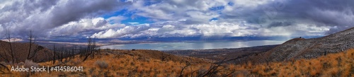 Lake Mountains Peak winter snow mountain hiking trail views via Israel Canyon towards Radio Towers, Utah Lake, Wasatch Front Rocky Mountains, Provo, Utah County. United States.