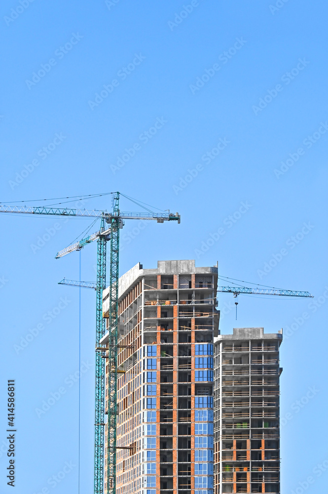 Crane and highrise construction site Crane and highrise construction site