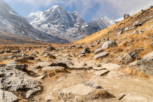 Hiking trail leading to the Annapurna base camp with the Annapurna Dakshin peak in the Himalayas in Nepal