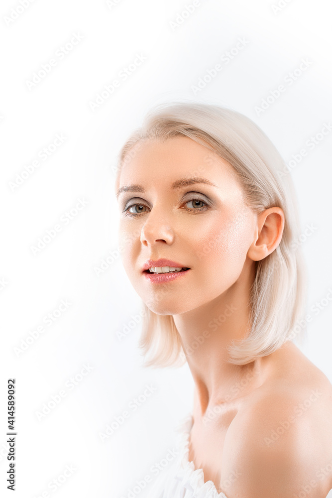 vertical photo of a beautiful smiling gentle young blonde woman with glowing skin on a white background vertical photo of a beautiful smiling gentle young blonde woman with glowing skin on a white background