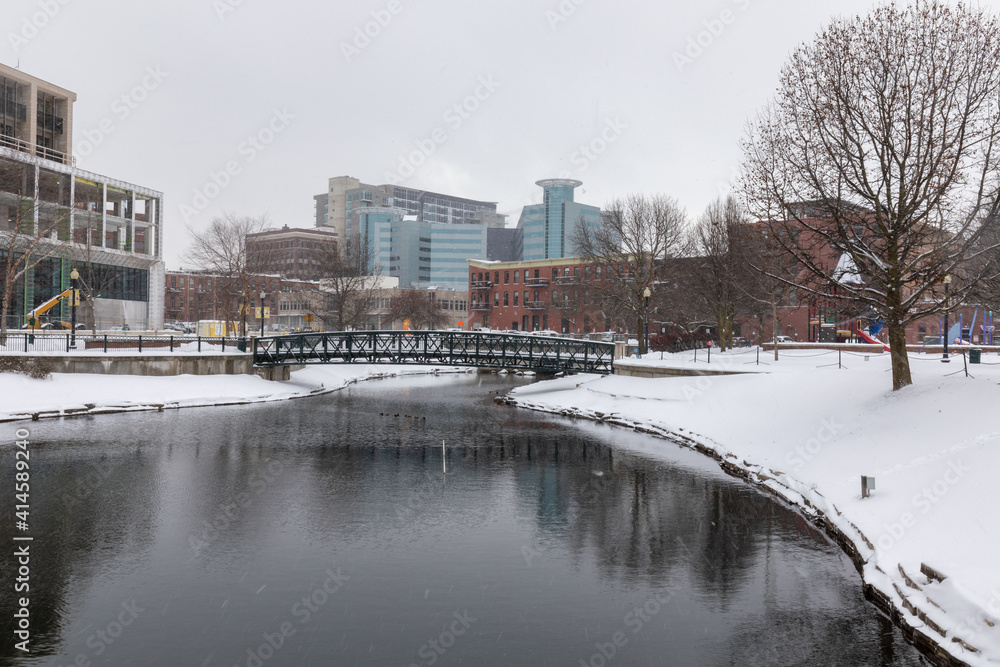 Kalamazoo, Michigan, USA - February 5 2021: Downtown Kalamazoo in snow. view from Arcadia Creek playground.
