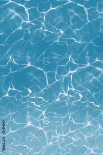 Rippled pattern of clean water in a blue swimming pool background closeup, concept sun light, water surface