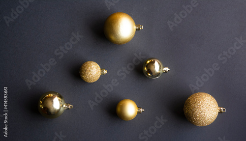 Golden Christmas balls on a grey background
