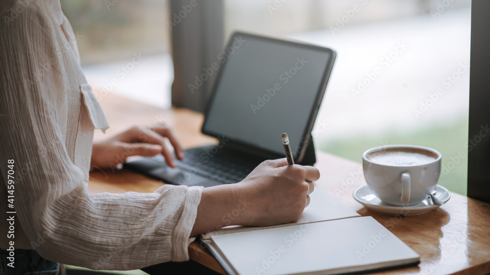 Image of businesswoman sitting taking note at the coffee shop. Image of businesswoman sitting taking note at the coffee shop.