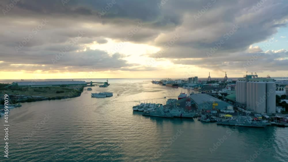 Golden sunset seen from Port Louis harbor. Aerial wide shot of industrial area. Golden sunset seen from Port Louis harbor. Aerial wide shot of industrial area.
