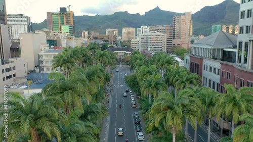 Aerial shot of palm lined street in downtown Port Louis with amazing cityscape and mountains in the horizon.