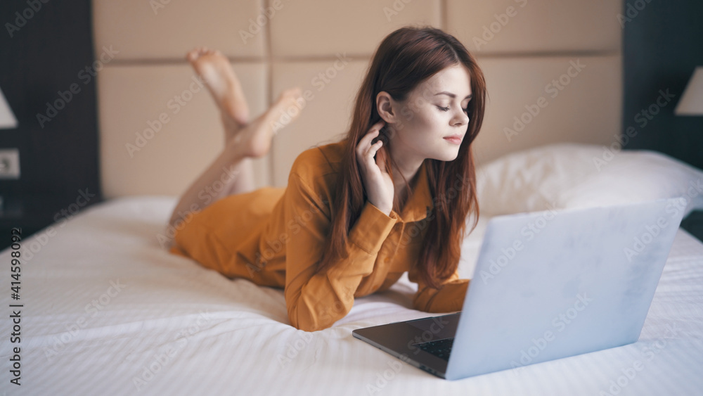 emotional woman lying in bed in front of laptop internet technology communication work emotional woman lying in bed in front of laptop internet technology communication work