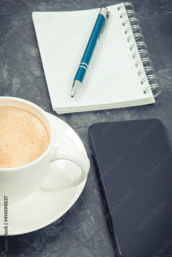 Smartphone, coffee with milk and notepad for notes. Work or relaxation with mobile phone Smartphone, coffee with milk and notepad for notes. Work or relaxation with mobile phone