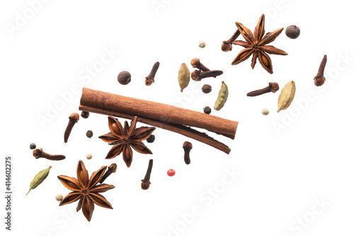 various flying spices for making masala tea isolated on white background