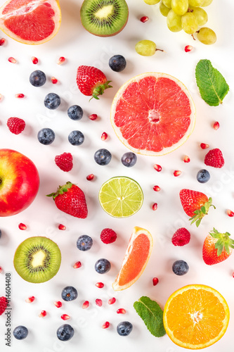 Fototapeta Naklejka Na Ścianę i Meble -  Fresh fruit. Citrus fruits, blueberries, strawberries, and mint, overhead flat lay shot on a white background