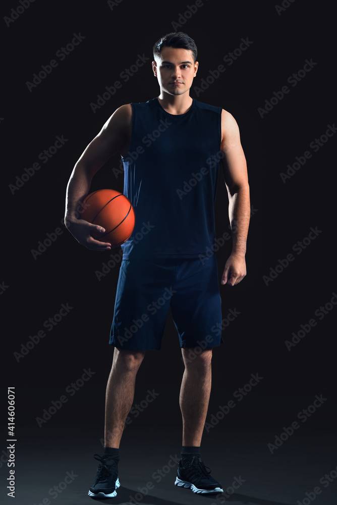 Male basketball player on dark background