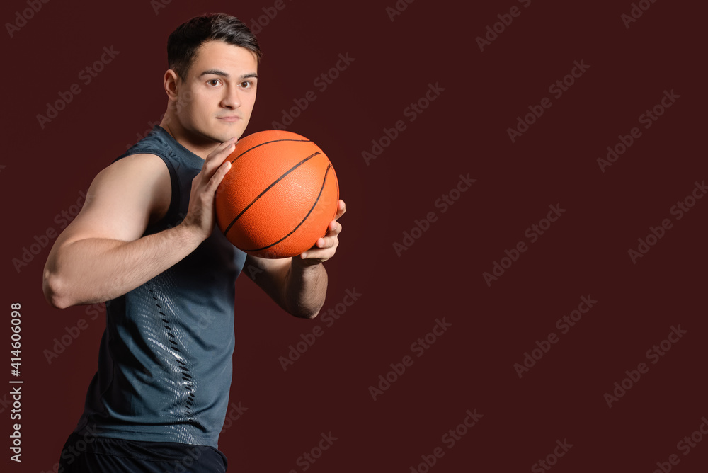 Male basketball player on dark color background
