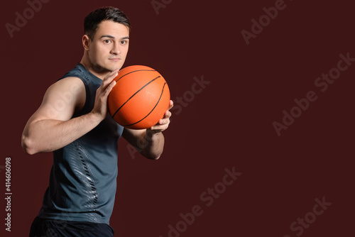 Male basketball player on dark color background